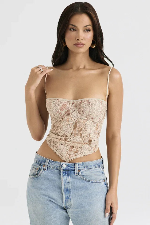 Front view of a woman in a beige lace corset top with a scarf hem and spaghetti straps.
