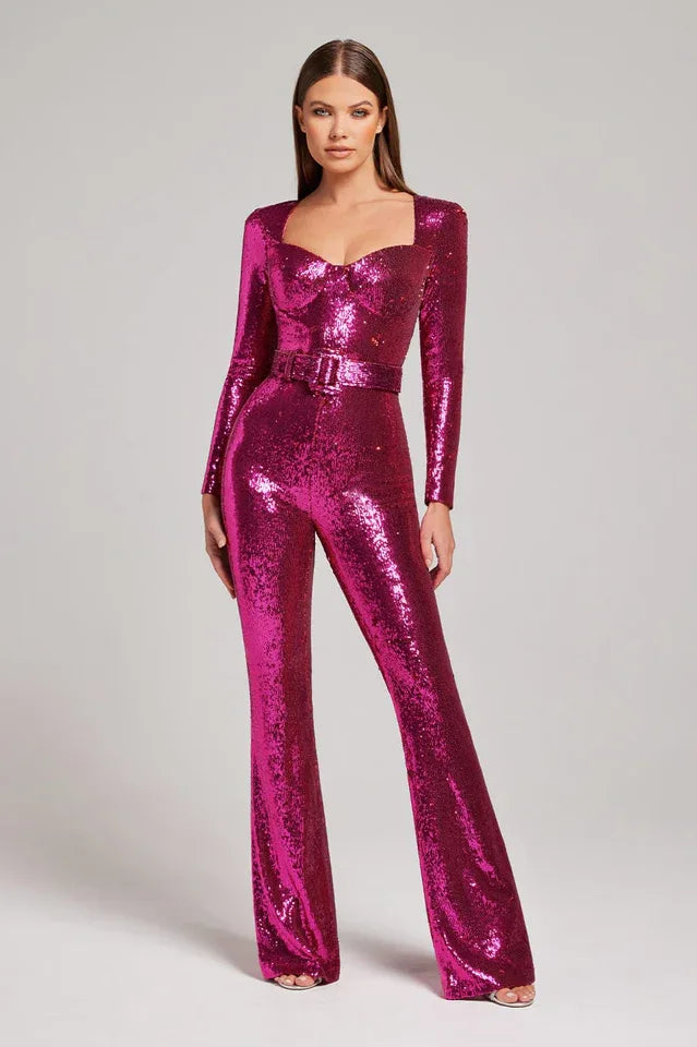 Front view of a woman modeling a glamorous pink sequined jumpsuit with a sweetheart neckline and a matching belt.