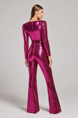 Back view of a woman in a dazzling pink sequined jumpsuit with long sleeves and flared legs.
