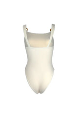 Cream-colored one-piece swimsuit with cut-out details and ring accents, back view.