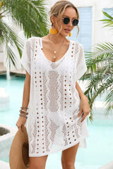 Front view of a woman in a white crochet knit beach cover-up.