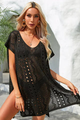 Close-up of a woman wearing a black crochet knit beach cover-up.