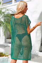 Back view of a woman wearing a dark green sheer knit tunic over a bikini