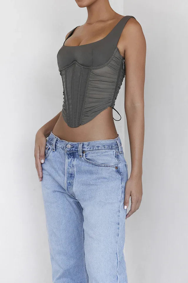 Close-up of a woman's torso in a khaki ruched corset top with a square neckline.