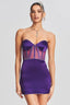 Model wearing a strapless purple satin mini dress with sheer corset-inspired panels and crystal embellishments.