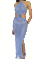 Close-up of a woman wearing a blue crochet knit maxi dress with a halter neck and cut-out details.