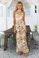 woman wearing a floral print maxi dress with a halter neckline