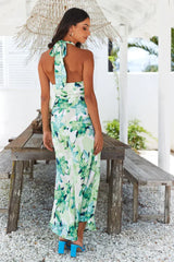 woman from behind in a green floral print maxi dress