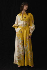 Full length view of a woman in a floral print linen matching set.