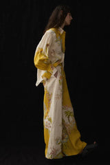 Profile view of a woman in a flowy floral print linen ensemble.