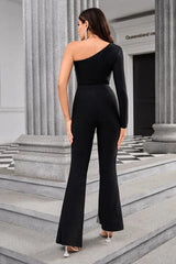 Back view of a woman in a black one-shoulder jumpsuit with flared trousers.