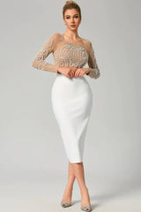 Woman wearing a sheer embellished crop top and white pencil skirt, front view