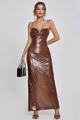 Woman in a shimmering bronze sequined evening gown with floral applique bust detail, spaghetti straps, and a floor-length hem.