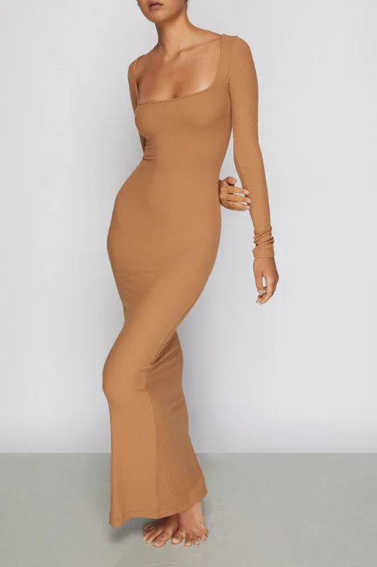 Woman wearing a long-sleeved, ribbed knit, square-neck, brown maxi dress, front view.