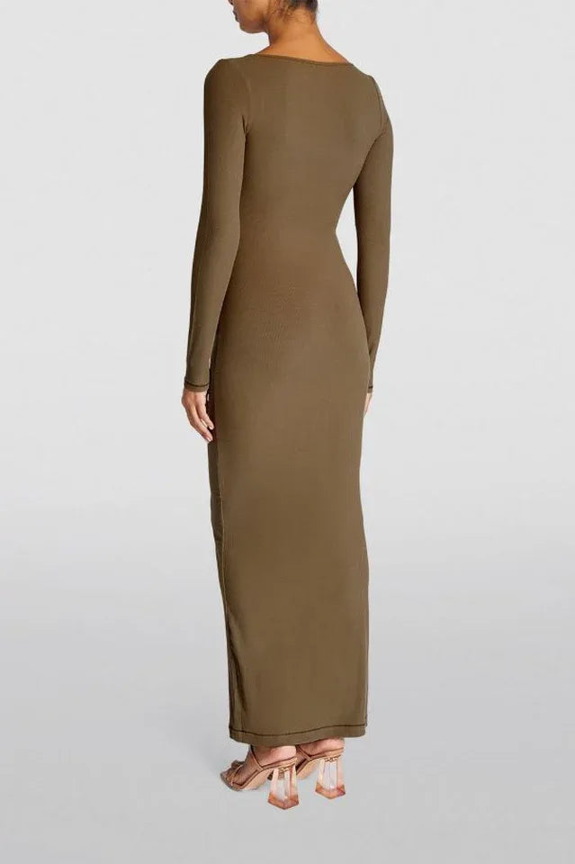 Woman wearing a long-sleeved, ribbed knit, square-neck, olive green maxi dress, back view.