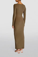 Woman wearing a long-sleeved, ribbed knit, square-neck, olive green maxi dress, back view.