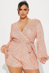 close-up of a woman wearing a pink sequin romper
