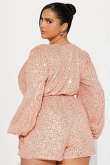 rear view close-up of a woman in a pink sequin romper