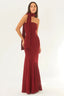 Woman wearing a red strapless mermaid gown with a scarf wrapped around her neck and trailing down her back