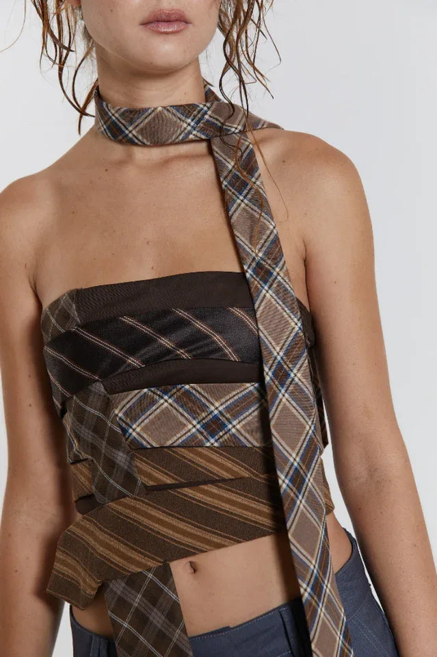 Detail shot of the strapless plaid top and necklace