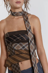 Detail shot of the strapless plaid top and necklace