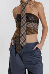 Front view of the strapless plaid top with hands in pockets