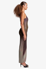 Woman wearing a sheer, ombre knit maxi dress with spaghetti straps, side view.