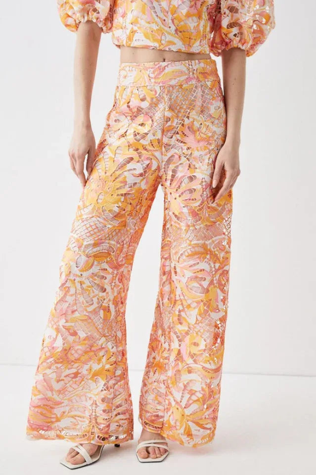 Close-up of the wide-leg pants, emphasizing the floral lace overlay and flowing silhouette.