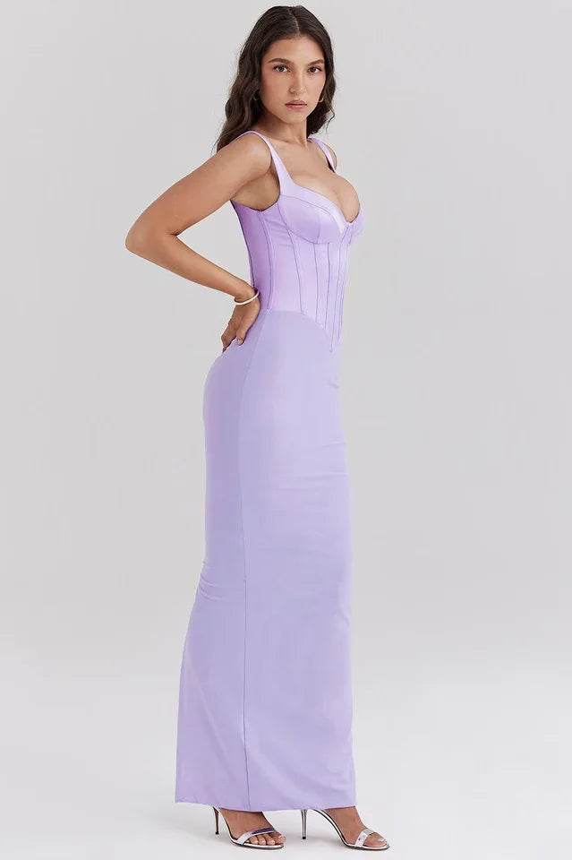 Side view of a woman wearing a long lavender corset dress with a square neckline and spaghetti straps.