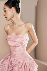 close-up of a pink strapless dress with intricate ruching on the bodice