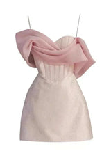 Product shot of a pink off-the-shoulder mini dress with a textured bodice and chiffon overlay