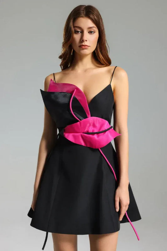 Black mini dress with vibrant pink floral applique detail and thin spaghetti straps, front view