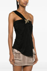 Black one-shoulder draped top with butterfly detail styled with a neutral cargo skirt
