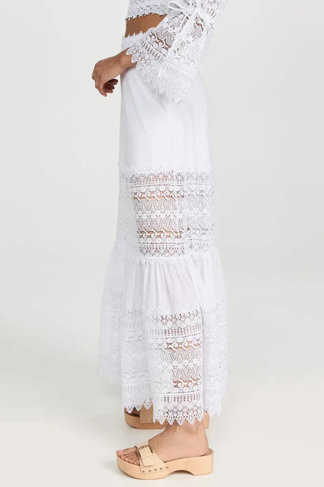 Detail of the white lace bell sleeves and cropped blouse neckline.