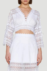 Front view of the white lace cropped blouse and maxi skirt set, emphasizing the V-neck and lace details.