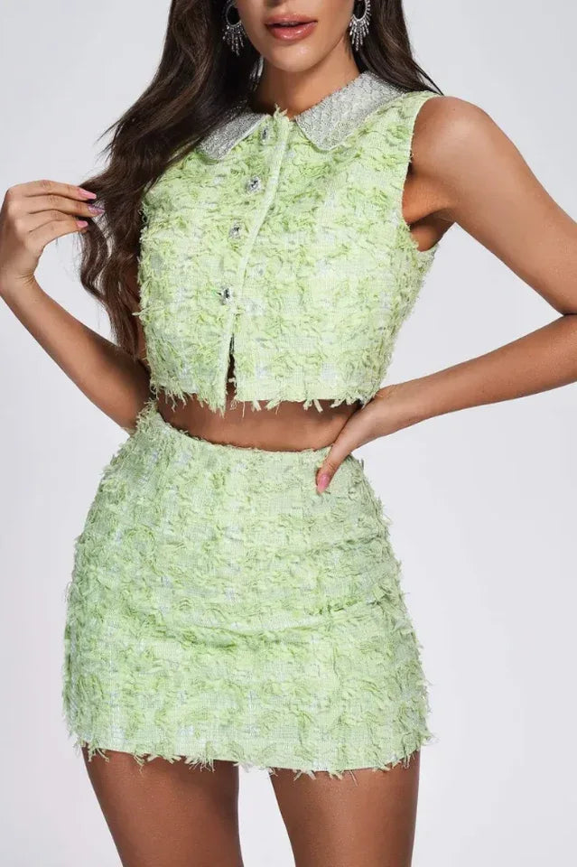 Model wearing a lime green textured tweed crop top and mini skirt set with embellished collar.