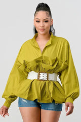 Front view of a woman in a lime green peplum top with a ruffled neckline and pleated hem, cinched with a white belt.