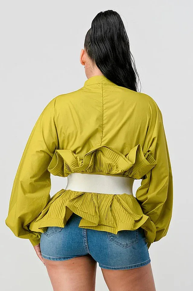 Back view of a woman's lime green peplum top with ruffled detailing at the waist and balloon sleeves.