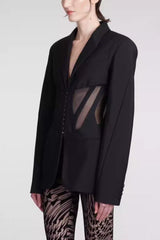 Side view of black fitted blazer with sheer corset detail