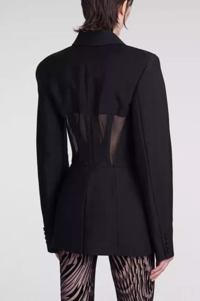 Back view of black fitted blazer with sheer corset detail
