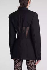 Back view of black fitted blazer with sheer corset detail