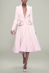 Model wearing a pink blazer and skirt set with rose embellishments