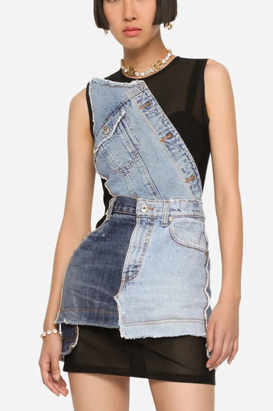 Model wearing a sleeveless black mesh mini dress with an asymmetrical deconstructed denim overlay