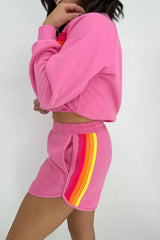 Close-up of the side detail on pink shorts with rainbow stripes.