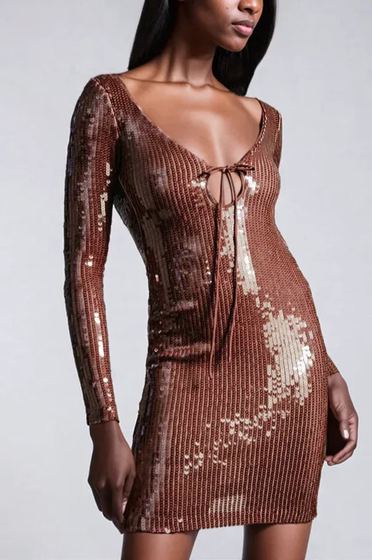 Woman wearing a long-sleeved, brown sequined mini dress with a plunging neckline and tie detail, shown from the front.