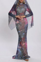 Full body shot of a woman in a cosmic-print gown with a flowing sheer veil.