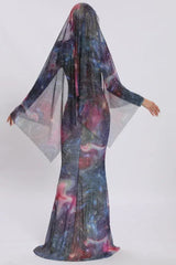 Back view of a woman in a shimmering galaxy dress with a dramatic sheer cape.