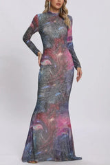 Front view of a woman showcasing a long-sleeved, high-neck galaxy print dress with glitter accents.
