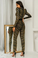 Back view of a woman in a black and gold rhinestone embellished set, highlighting the zipper detail.