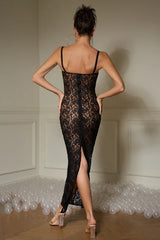 Back view of a woman wearing a black lace maxi dress with a high slit.
